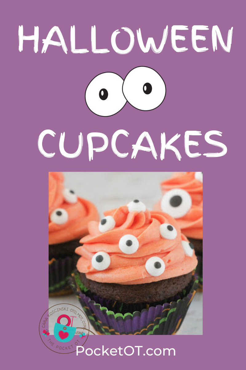 cupcake with orange icing and eye candy
